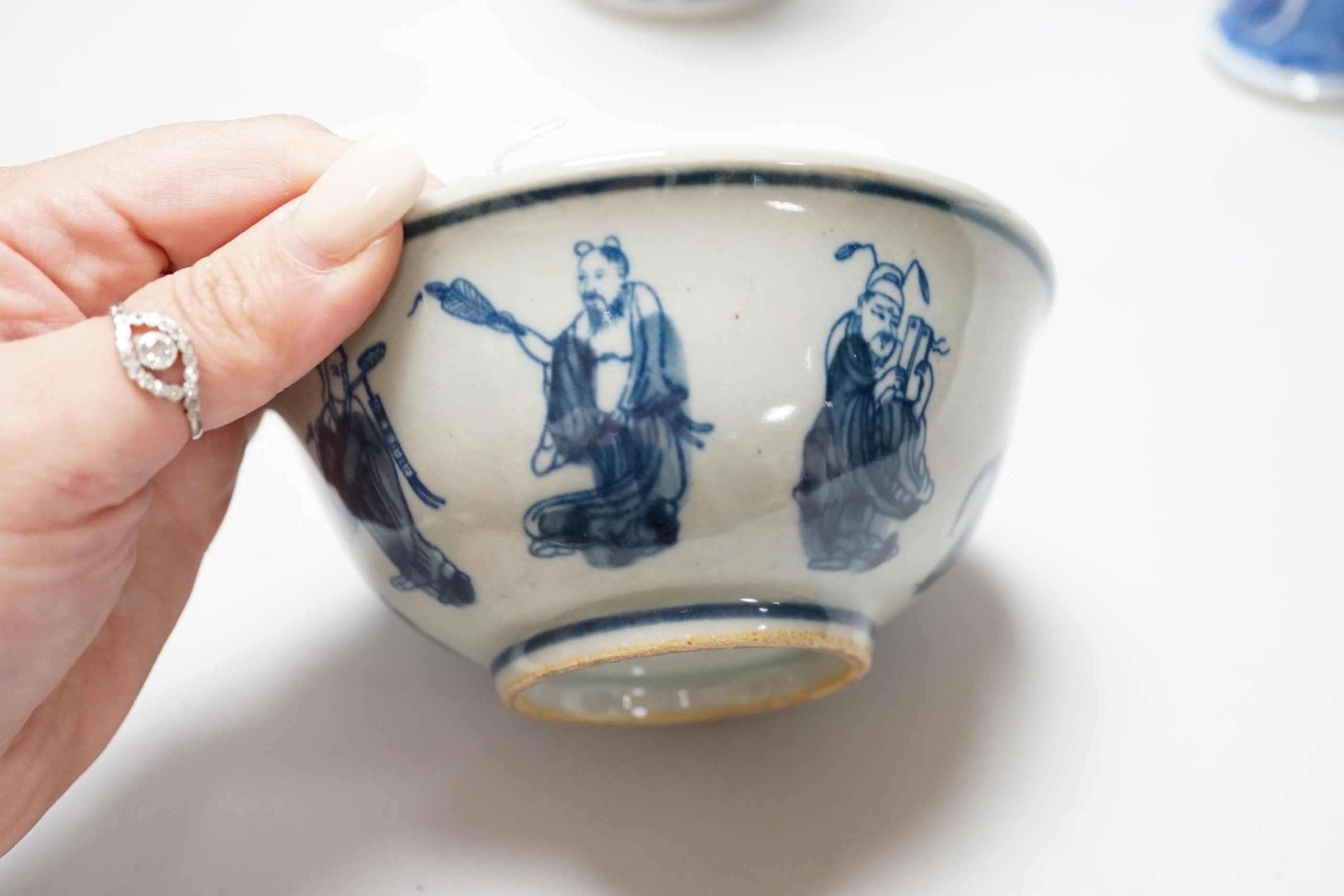 A group of Chinese blue and white ceramics including two prunus flower vases and three bowls, the largest 26cm in diameter
